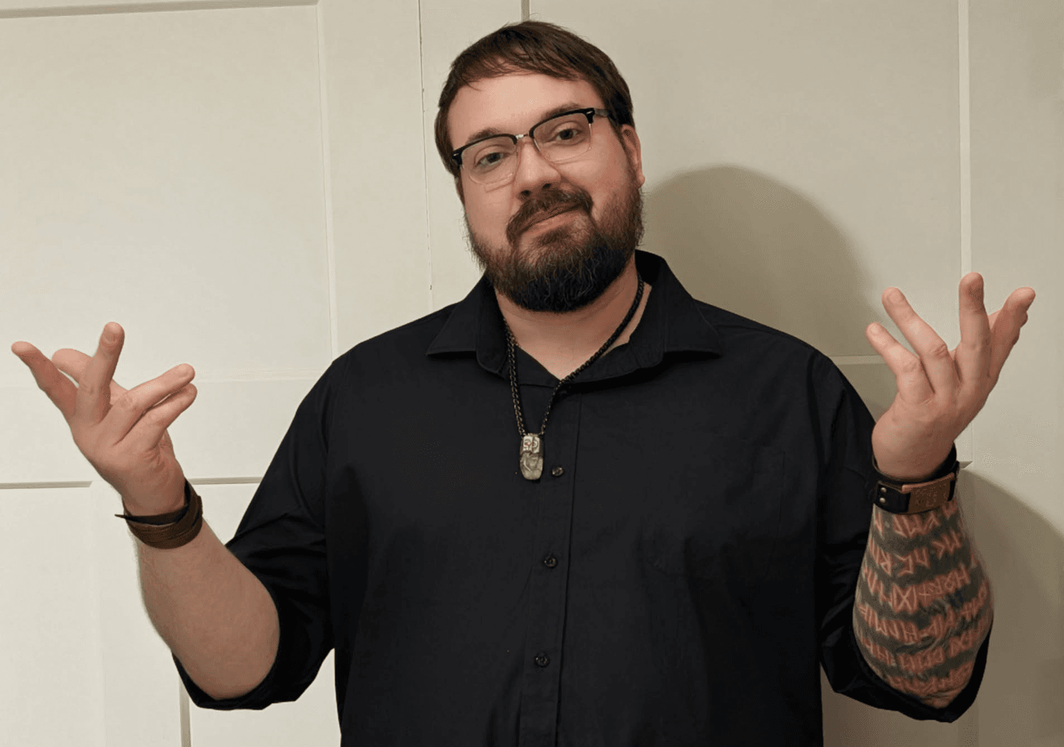 Portrait of the founder in a relaxed pose with both arms visible.